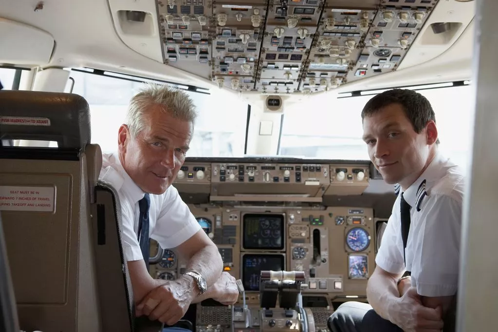 0_Pilot-and-co-pilot-looking-over-shoulders-in-cockpit-portrait